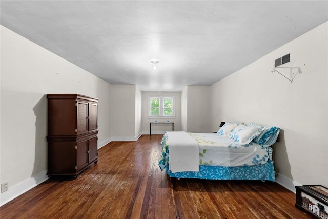 bedroom with dark hardwood / wood-style floors