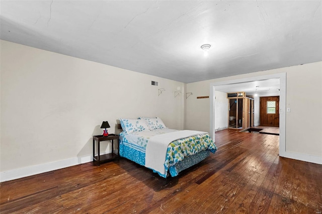 bedroom with dark wood-type flooring