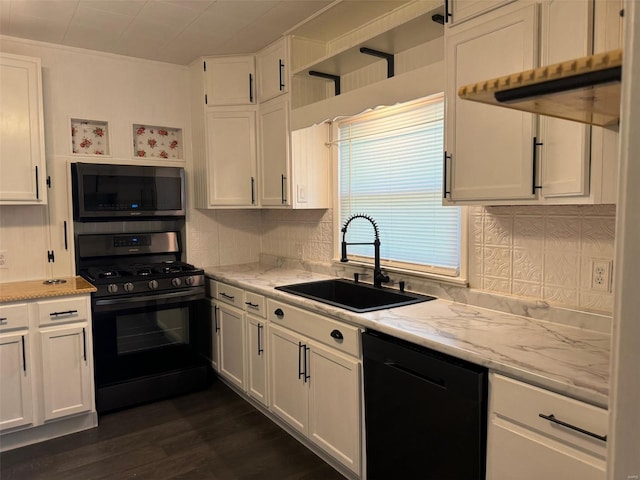 kitchen featuring black appliances, light stone counters, sink, dark hardwood / wood-style floors, and white cabinets