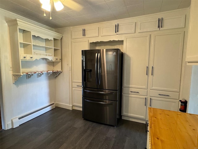 kitchen featuring white cabinets, stainless steel fridge, a baseboard radiator, dark hardwood / wood-style floors, and ceiling fan