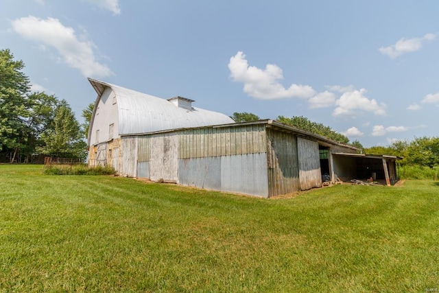 view of property exterior featuring a yard and an outbuilding