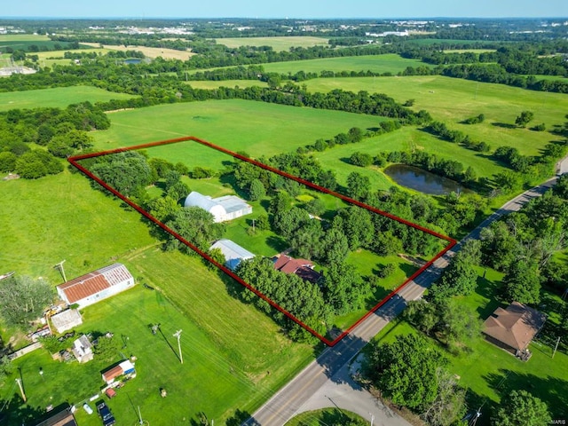 birds eye view of property featuring a water view and a rural view