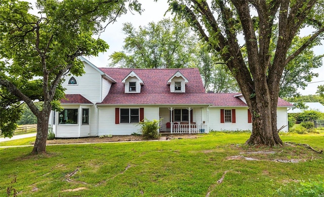 cape cod-style house featuring a porch and a front lawn