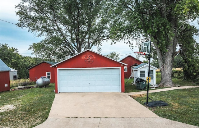 view of front facade featuring a garage, an outbuilding, and a front lawn