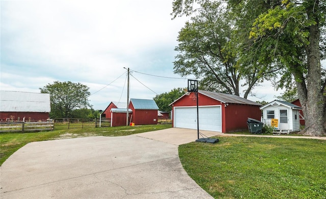 view of front of home with a garage, an outbuilding, and a front yard