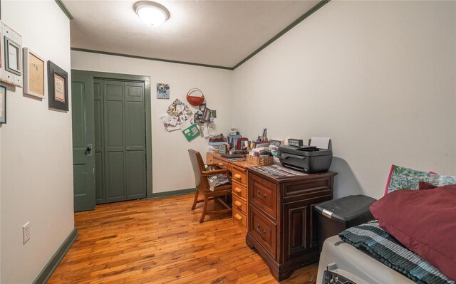 office area featuring light hardwood / wood-style flooring and ornamental molding