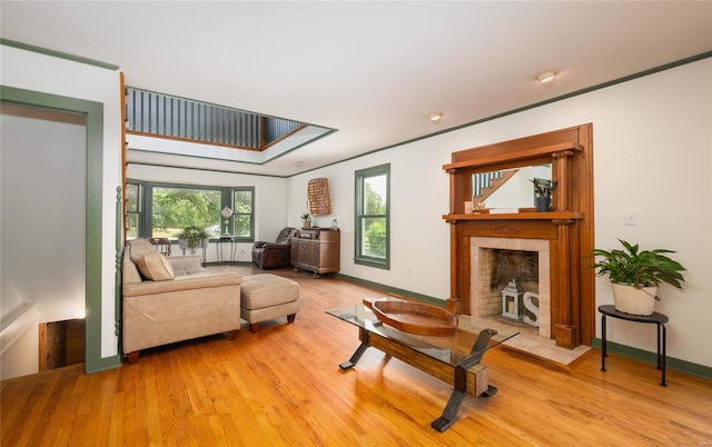 living room featuring light wood-type flooring and ornamental molding