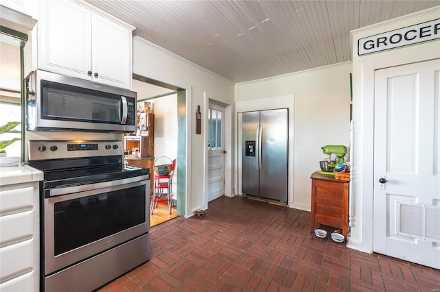 kitchen with white cabinets, crown molding, and appliances with stainless steel finishes