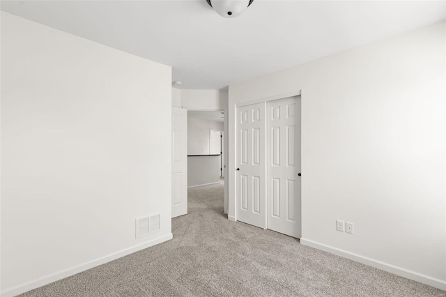 empty room featuring light colored carpet