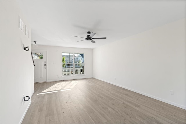 unfurnished room with ceiling fan and light wood-type flooring