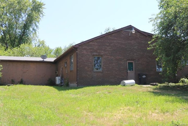 view of side of home with a lawn