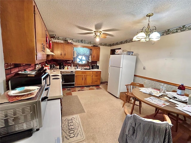 kitchen featuring dishwasher, a textured ceiling, decorative light fixtures, and white fridge