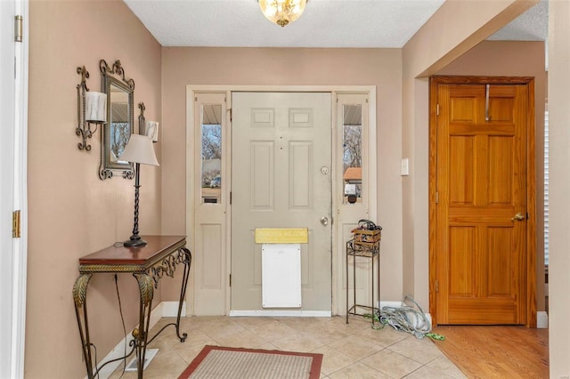 entrance foyer featuring a textured ceiling and light hardwood / wood-style flooring