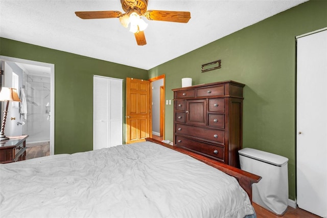 bedroom with ensuite bathroom, ceiling fan, and hardwood / wood-style flooring