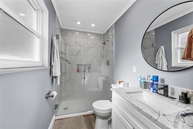 bathroom featuring vanity, toilet, ornamental molding, walk in shower, and wood-type flooring