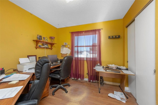 office space featuring light hardwood / wood-style flooring and a textured ceiling