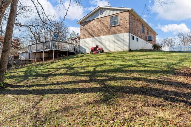 exterior space featuring a lawn and a deck