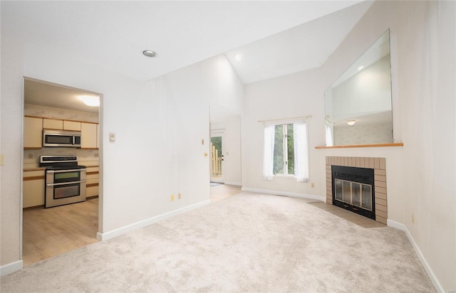 unfurnished living room with light carpet, a fireplace, and lofted ceiling