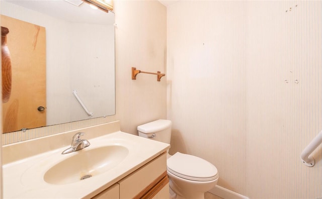 bathroom featuring toilet and vanity