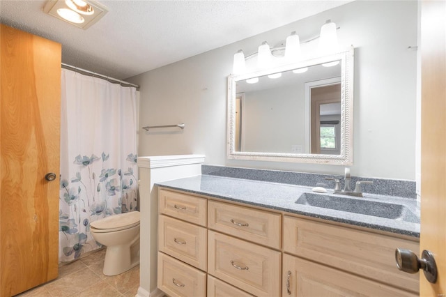 bathroom featuring toilet, a textured ceiling, tile patterned floors, and vanity