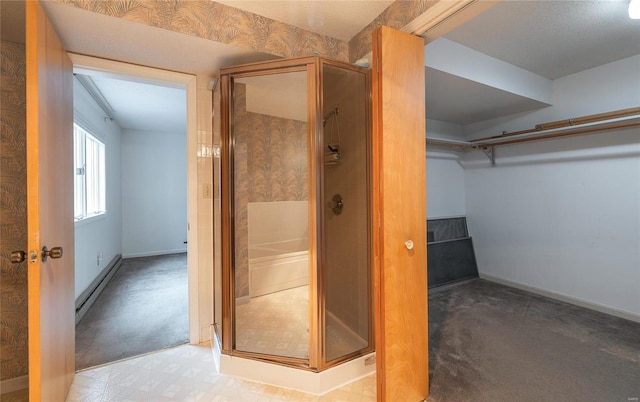 bathroom featuring walk in shower and a baseboard heating unit