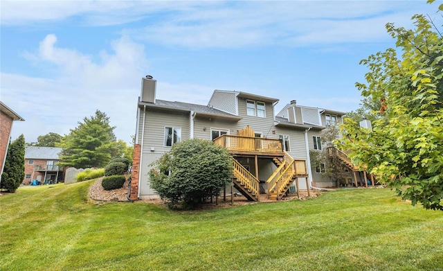 rear view of house featuring a yard and a deck