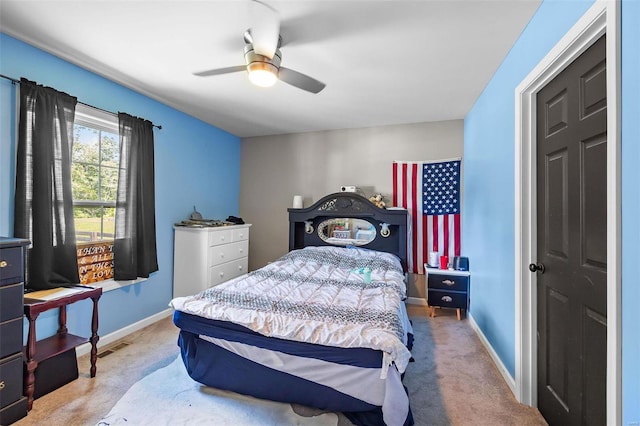 bedroom with ceiling fan and light colored carpet