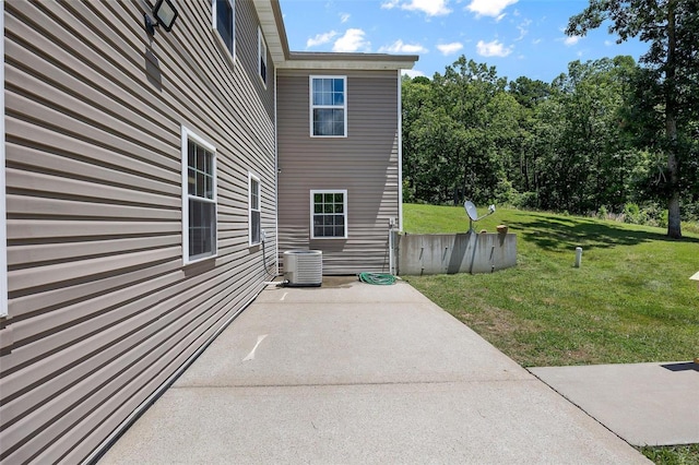 view of home's exterior featuring a lawn, a patio, and central air condition unit