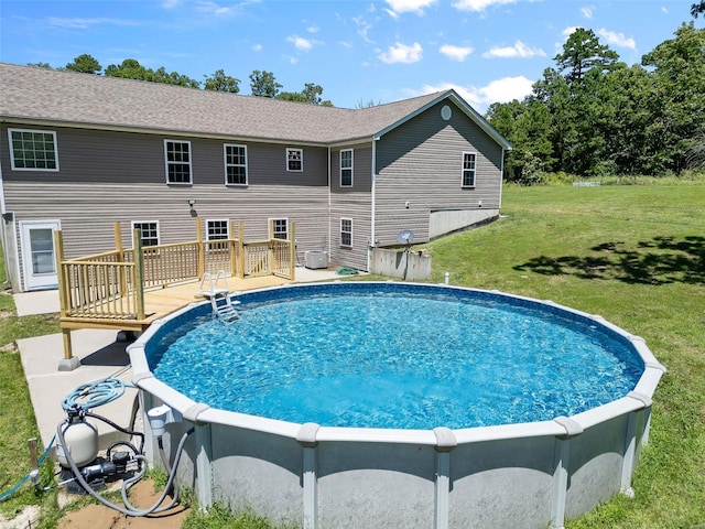 view of swimming pool featuring a yard and a deck