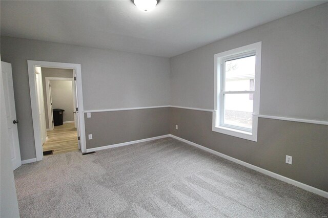 carpeted empty room with a healthy amount of sunlight