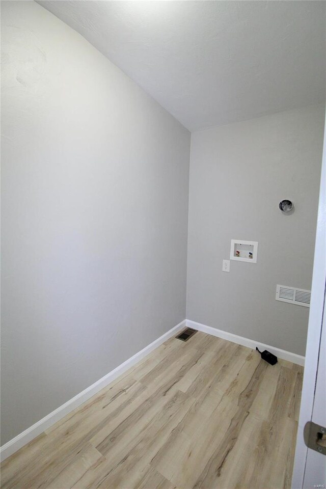 laundry area featuring light hardwood / wood-style flooring and washer hookup