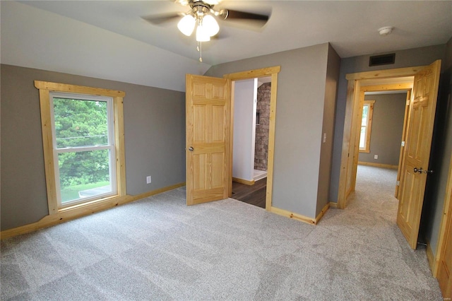 unfurnished bedroom with ceiling fan and light colored carpet