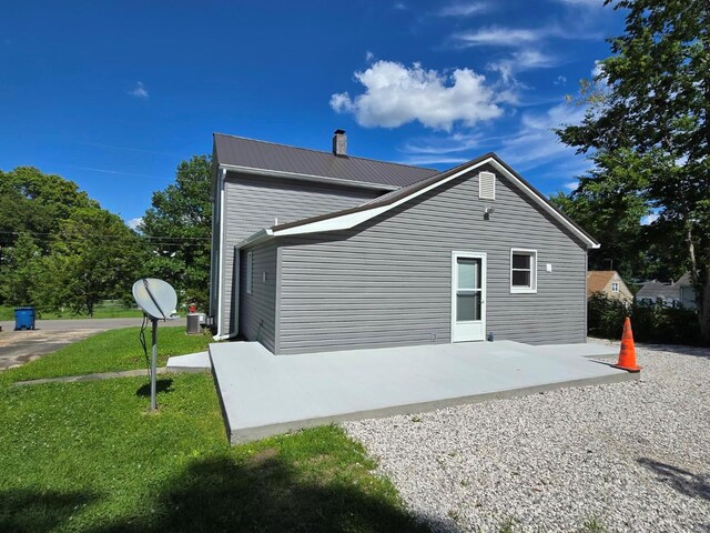 back of house with a yard and a patio area