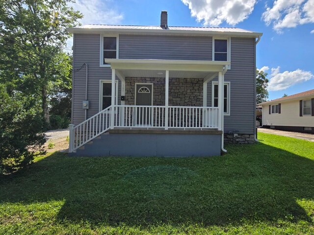 front of property with a front yard and covered porch