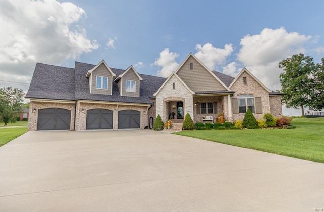 view of front of house with a garage and a front lawn