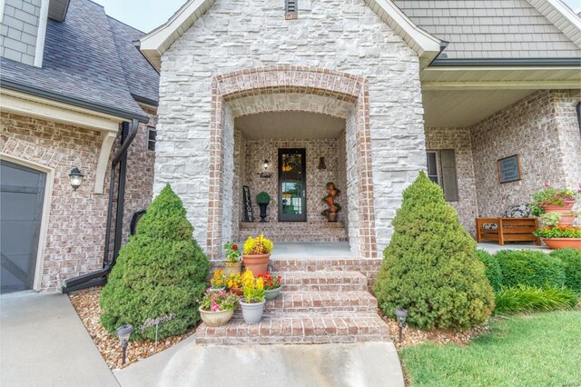 doorway to property with a garage