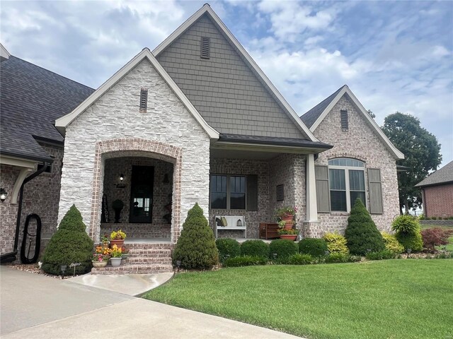 view of front of home with covered porch and a front yard