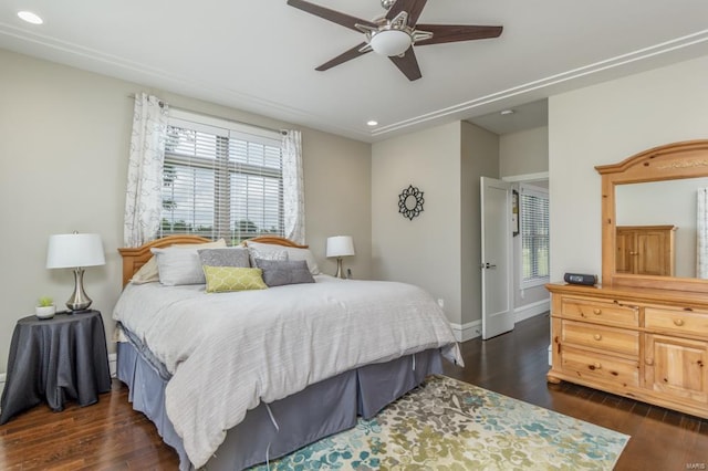 bedroom featuring dark hardwood / wood-style flooring, multiple windows, and ceiling fan