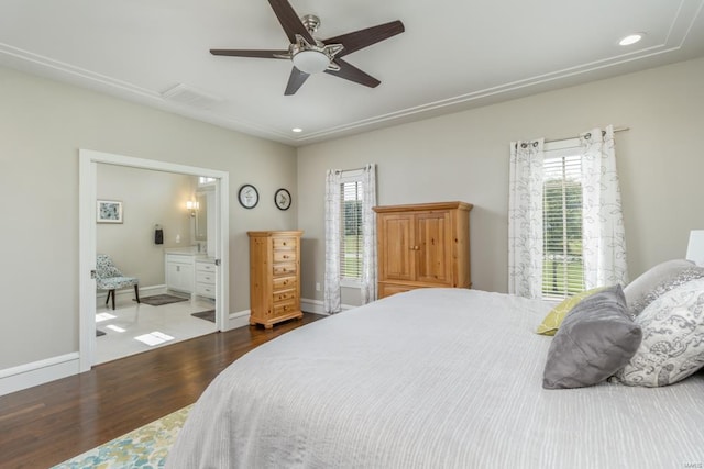 bedroom with connected bathroom, hardwood / wood-style flooring, and ceiling fan