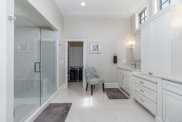 bathroom with a shower with shower door, tile patterned floors, and vanity