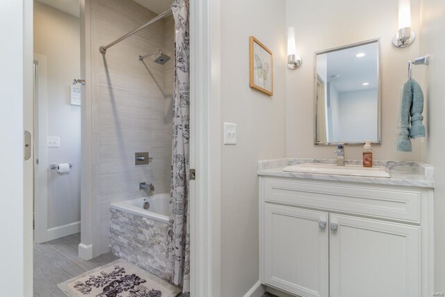 bathroom with shower / tub combo, hardwood / wood-style flooring, and vanity