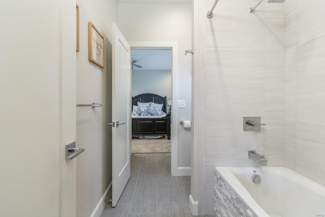 bathroom featuring tile patterned floors and tiled shower / bath