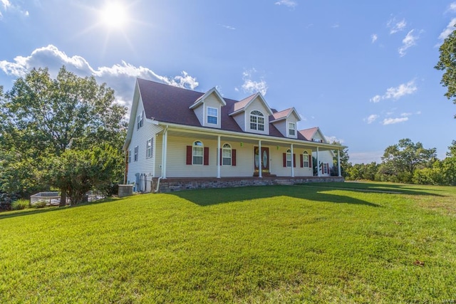 cape cod house with covered porch, central air condition unit, and a front lawn