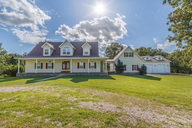 cape cod home featuring a porch, a garage, and a front yard