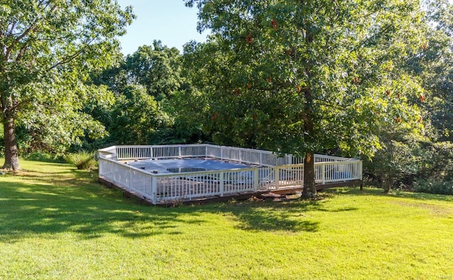 view of swimming pool with a deck and a yard