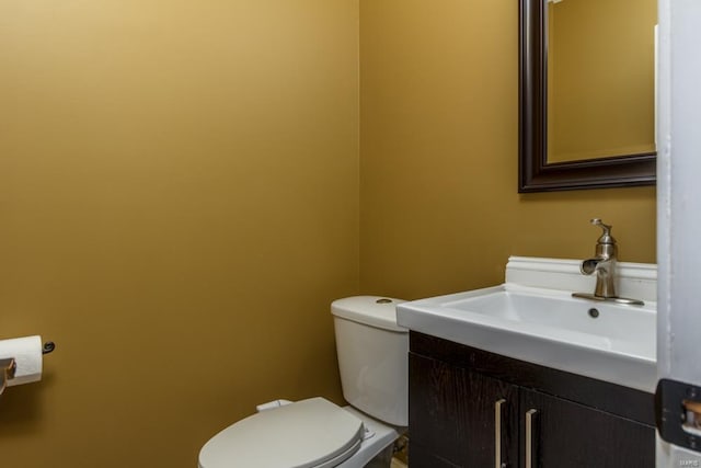 bathroom featuring toilet and vanity