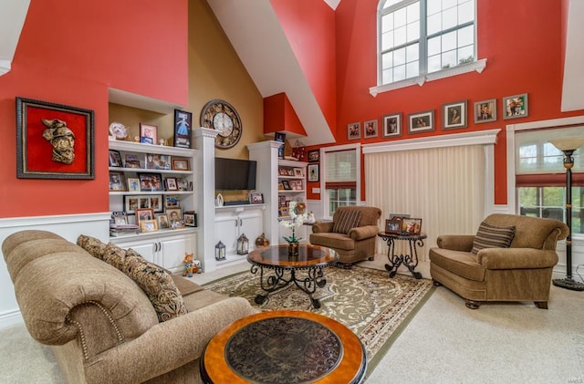 living room with built in shelves, carpet flooring, and high vaulted ceiling