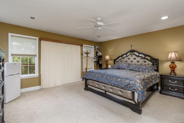 carpeted bedroom with white fridge and ceiling fan