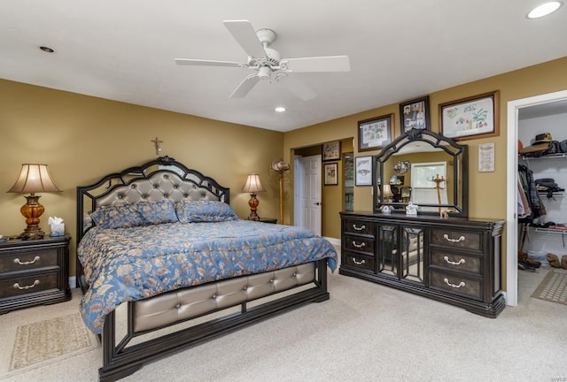 bedroom with ceiling fan, carpet, a closet, and a walk in closet