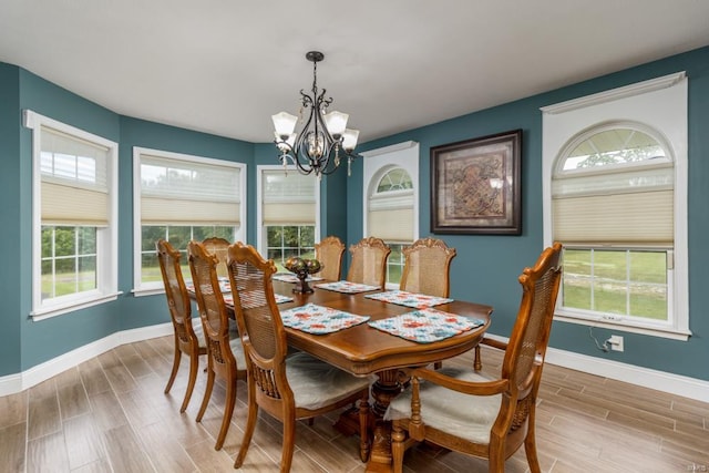 dining area with an inviting chandelier, wood-type flooring, and a wealth of natural light